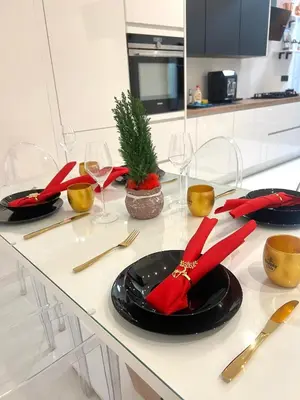 a table with black plates and red napkins and wine glasses at Wenceslas square apartment 150 m2 in Prague