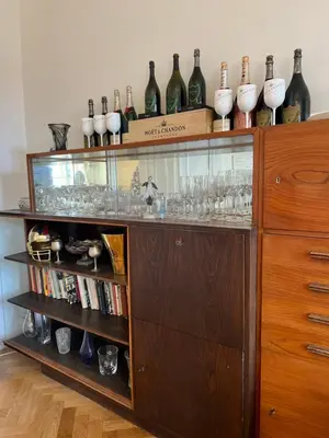 a display cabinet with wine bottles and glasses on it at Wenceslas square apartment 150 m2 in Prague