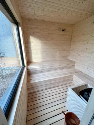 a wooden sauna with a bench in a room at Apartmány Pekárna 1898 in Beroun