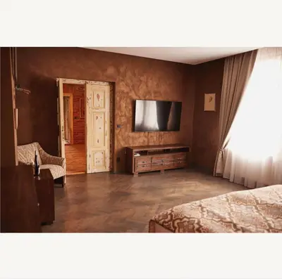 a bedroom with two beds and a flat screen tv at Apartmány Pekárna 1898 in Beroun