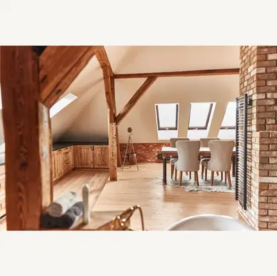 a kitchen and dining room with wooden beams at Apartmány Pekárna 1898 in Beroun
