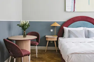a bedroom with a bed and a table and chairs at Numa Prague Flow in Prague