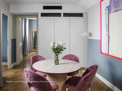 a dining room with a table and purple chairs at Numa Prague Flow in Prague