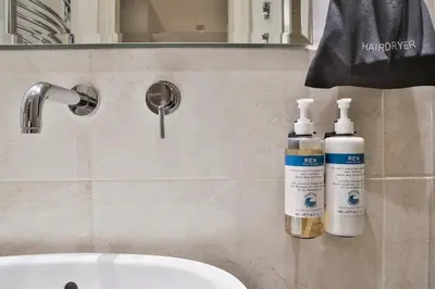 two bottles ofodorizers are sitting on a bathroom counter at Numa Prague Flow in Prague