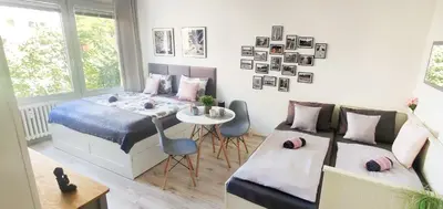 a bedroom with a bed and a table and a couch at King Size Sunny Home 19 minutes to Center in Prague