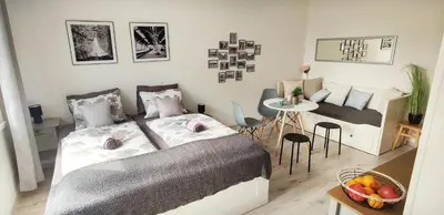 a bedroom with a bed and a table and a dining room at King Size Sunny Home 19 minutes to Center in Prague
