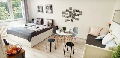 a bedroom with a bed and a table and a couch at King Size Sunny Home 19 minutes to Center in Prague