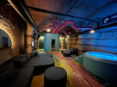 a living room with a hot tub in a brick wall at SPA SPA Opletalova in Prague