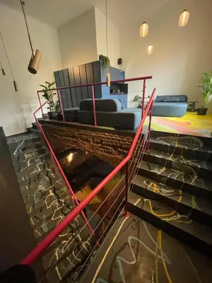 a room with stairs and a living room with a couch at SPA SPA Opletalova in Prague