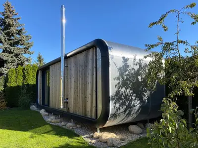 a large metal building with a picture of a tree at Luxusní apartmán v Praze Klánovicích na zahradě, 20 minut do centra Prahy in Šestajovice