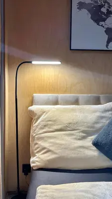 a bed with a white pillow and a lamp next to it at Luxusní apartmán v Praze Klánovicích na zahradě, 20 minut do centra Prahy in Šestajovice