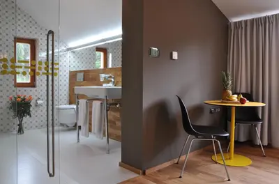 a bathroom with a table and a sink in a room at Hotel Kokořín in Kokořín