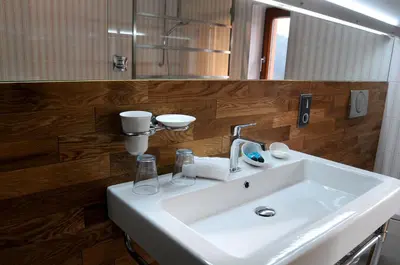 a bathroom with a white sink and a mirror at Hotel Kokořín in Kokořín