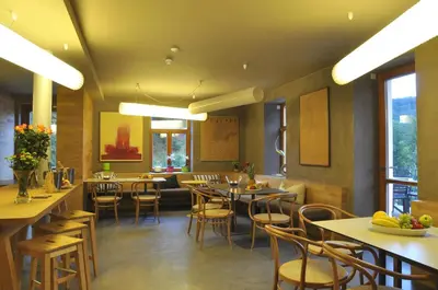 a restaurant with tables and chairs in a room at Hotel Kokořín in Kokořín