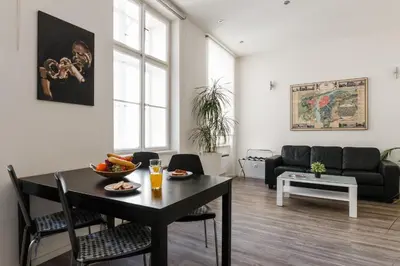a living room with a table and a couch at Prague Days - Open-plan Studio with AC near National Theatre in Prague