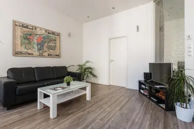 a living room with a couch and a coffee table at Prague Days - Open-plan Studio with AC near National Theatre in Prague