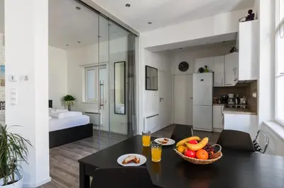 a room with a table with a bowl of fruit on it at Prague Days - Open-plan Studio with AC near National Theatre in Prague