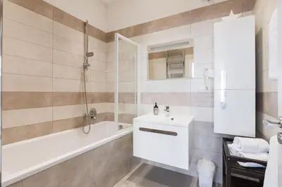 a bathroom with a tub and a sink and a shower at Prague Days - Open-plan Studio with AC near National Theatre in Prague