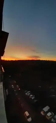 a group of cars parked in a parking lot at sunset at Apartment Kamýk in Prague