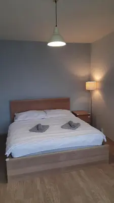 a bedroom with a bed with two towels on it at Apartment Kamýk in Prague