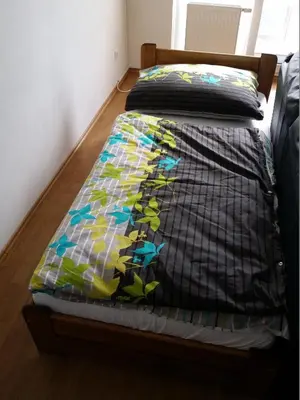 a bed with a quilt on top of it at Chotěšovská Apartment with Parking Place in Prague