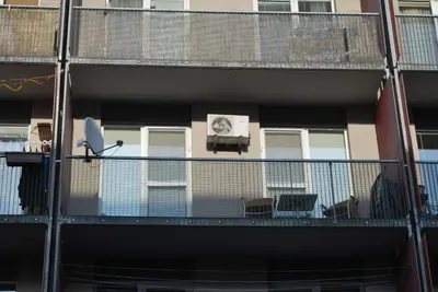 a balcony of a building with tables and chairs at Chotěšovská Apartment with Parking Place in Prague