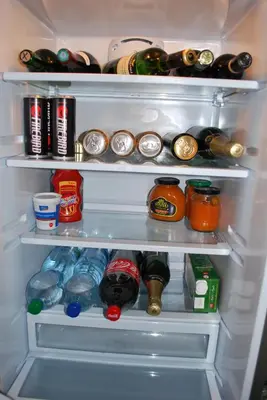 an open refrigerator filled with lots of food and drinks at Chotěšovská Apartment with Parking Place in Prague