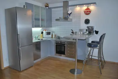 a kitchen with a stainless steel refrigerator and a counter at Chotěšovská Apartment with Parking Place in Prague
