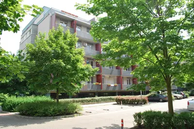 a building with trees in front of it at Chotěšovská Apartment with Parking Place in Prague
