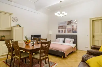 a bedroom with a bed and a table and chairs at Superb apartments near Dlouha street in Prague
