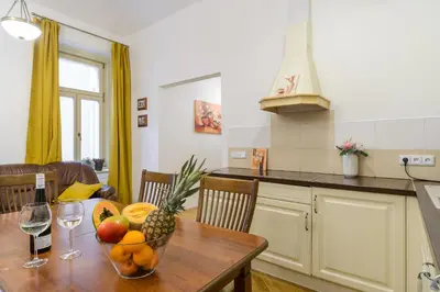 a kitchen with a table with a bowl of fruit on it at Superb apartments near Dlouha street in Prague