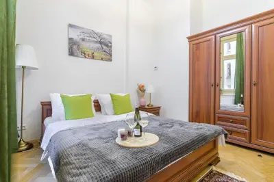 a bedroom with a bed with a table on it at Superb apartments near Dlouha street in Prague