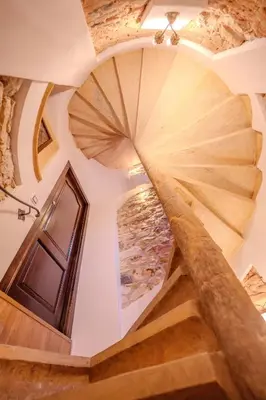a spiral staircase in a house with wooden floors at 2-Floor Traditional Prague Apartment in Prague