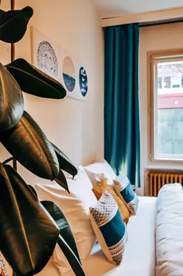 a bedroom with a bed with pillows and a plant at TurnKey I Studio by City Mall in Prague