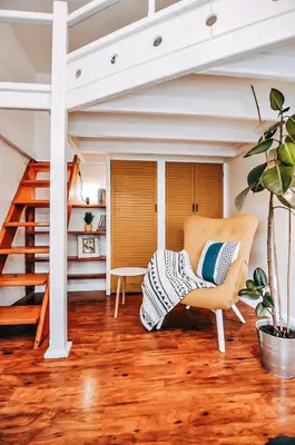 a living room with a chair and a staircase at TurnKey I Studio by City Mall in Prague