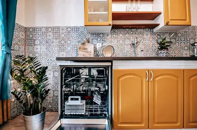 a kitchen with an open dishwasher in the middle at TurnKey I Studio by City Mall in Prague