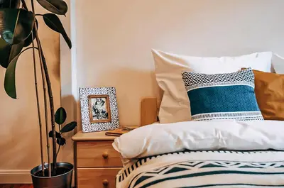 a bedroom with a bed with a pillow and a plant at TurnKey I Studio by City Mall in Prague