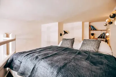 a bedroom with a large bed with two pillows at TurnKey I Studio by City Mall in Prague