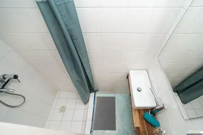 a bathroom with a shower with a toilet and a sink at Cozy Old Town Stay - 1-bedroom apartment in Prague
