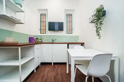 a kitchen with a white table and white chairs at Cozy Old Town Stay - 1-bedroom apartment in Prague