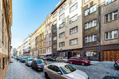 a row of cars parked on a street next to buildings at Cozy Old Town Stay - 1-bedroom apartment in Prague