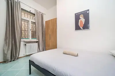 a white bed in a room with a window at Cozy Old Town Stay - 1-bedroom apartment in Prague