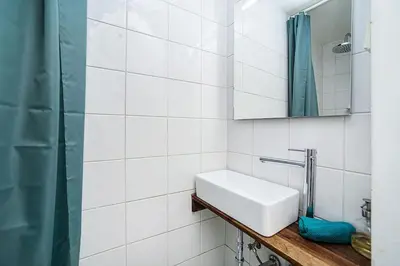 a white bathroom with a sink and a shower at Cozy Old Town Stay - 1-bedroom apartment in Prague