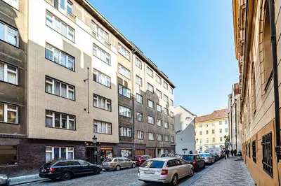 a city street with cars parked in front of buildings at Cozy Old Town Stay - 1-bedroom apartment in Prague