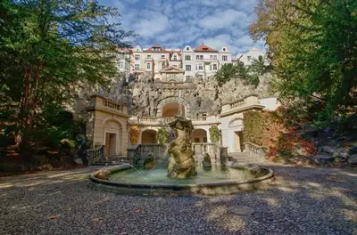 a house with a fountain in front of a building at TurnKey I Studio by Amazing Park in Prague