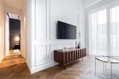 a bedroom with a large bed with a blue headboard at TurnKey I Premium Apartment in Prague