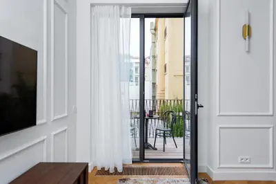 a light on a wall with a blue wall at TurnKey I Premium Apartment in Prague