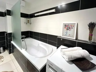 a bathroom with a bath tub and a sink at British Quarter Apartments in Prague