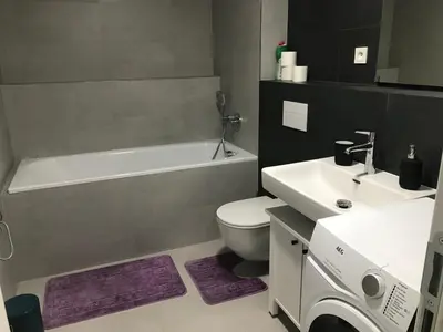 a bathroom with a white toilet and a sink at Apartmantplus02 in Prague