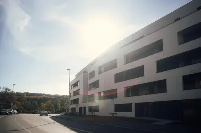 a white building on the side of a road at Apartmantplus02 in Prague